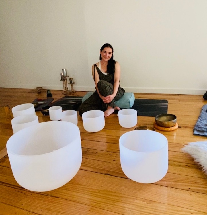 sound healer with crystal and tibetan sound bowls